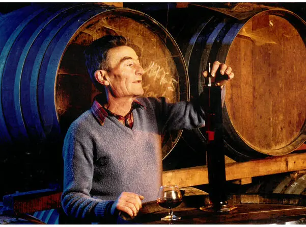 Cellar master tasting Armagnac among the casks