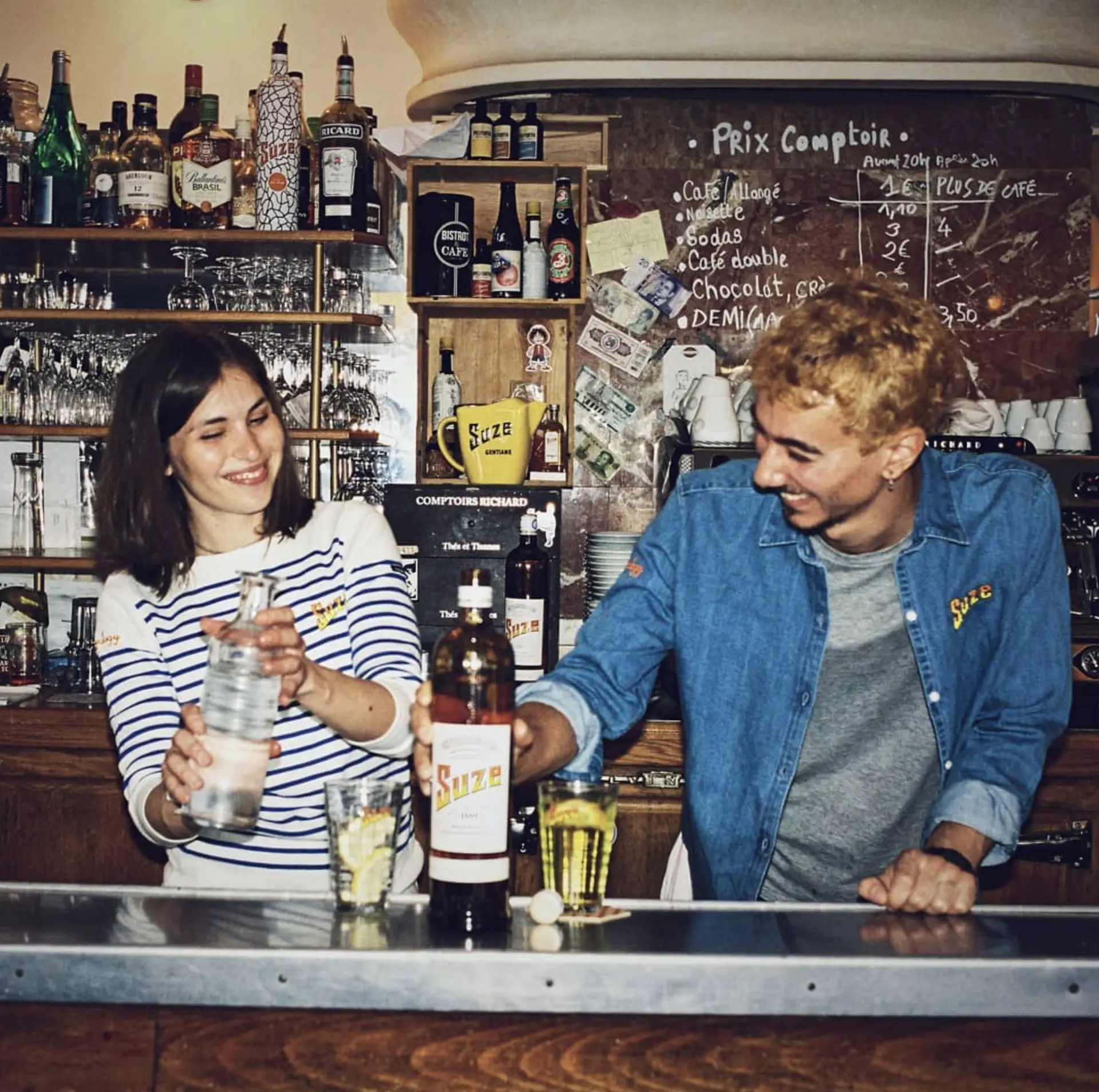 Couple mixing drinks with Suze at a bar